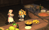 Alpha and Omega (toy form) observe a pastry chef Lalafell whipping something together in Raulf's brightly lit beside tables full of prepared ingredients: fruits, beans, wines and the like.